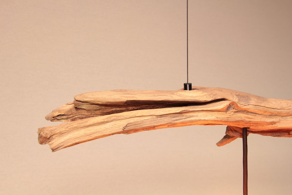 Handcrafted "Sonne und Wind II" oak branch pendant light with black cable and fittings, showing its natural, sun-exposed, light wood color.
